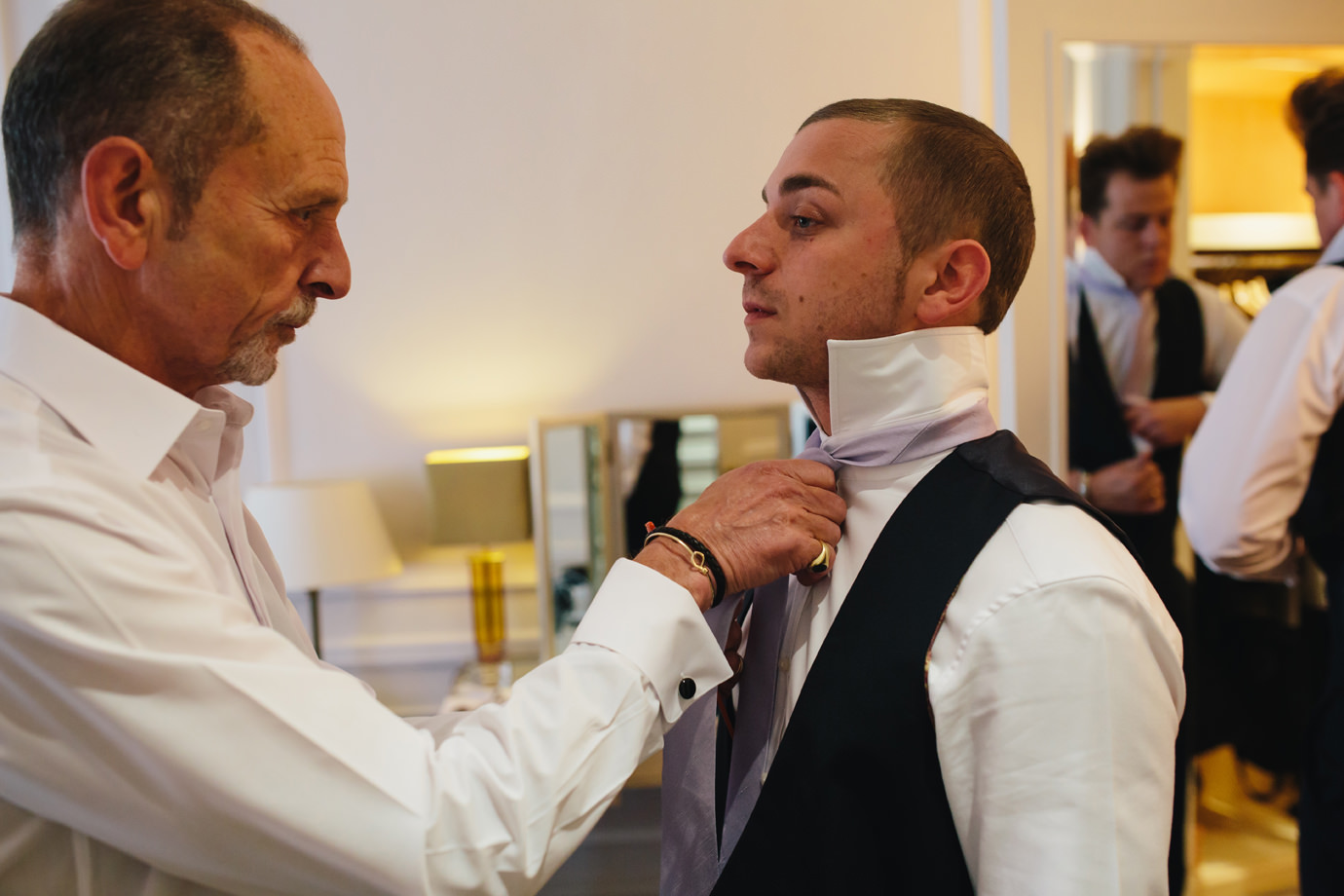 Groom and father getting dressed wedding photography