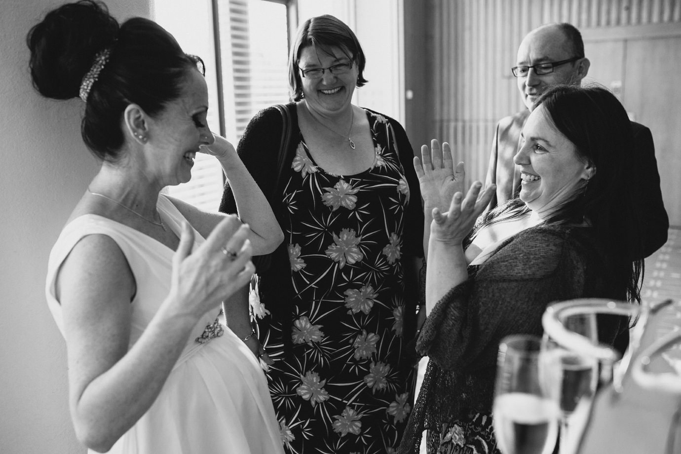 Bride meeting family and friends, candid wedding photography, London